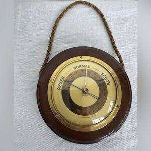 Vintage hanging wall barometer with brass face and wooden frame